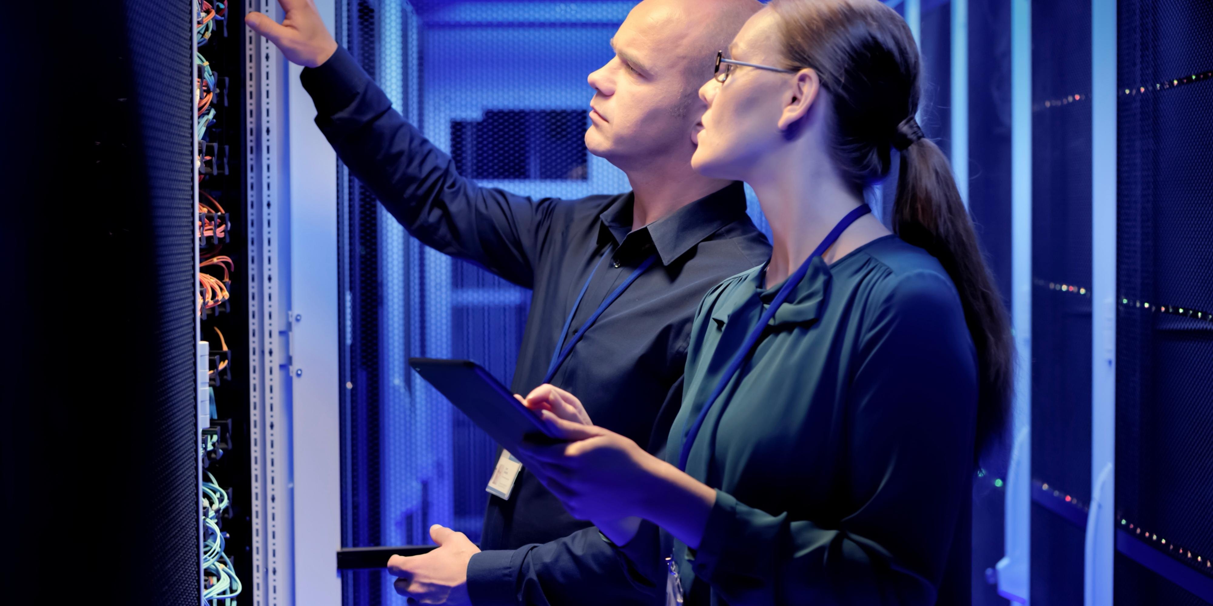 two it professionals in a server room