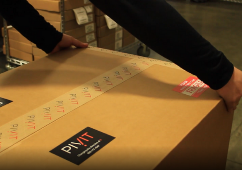 pivit warehouse technician taping a package
